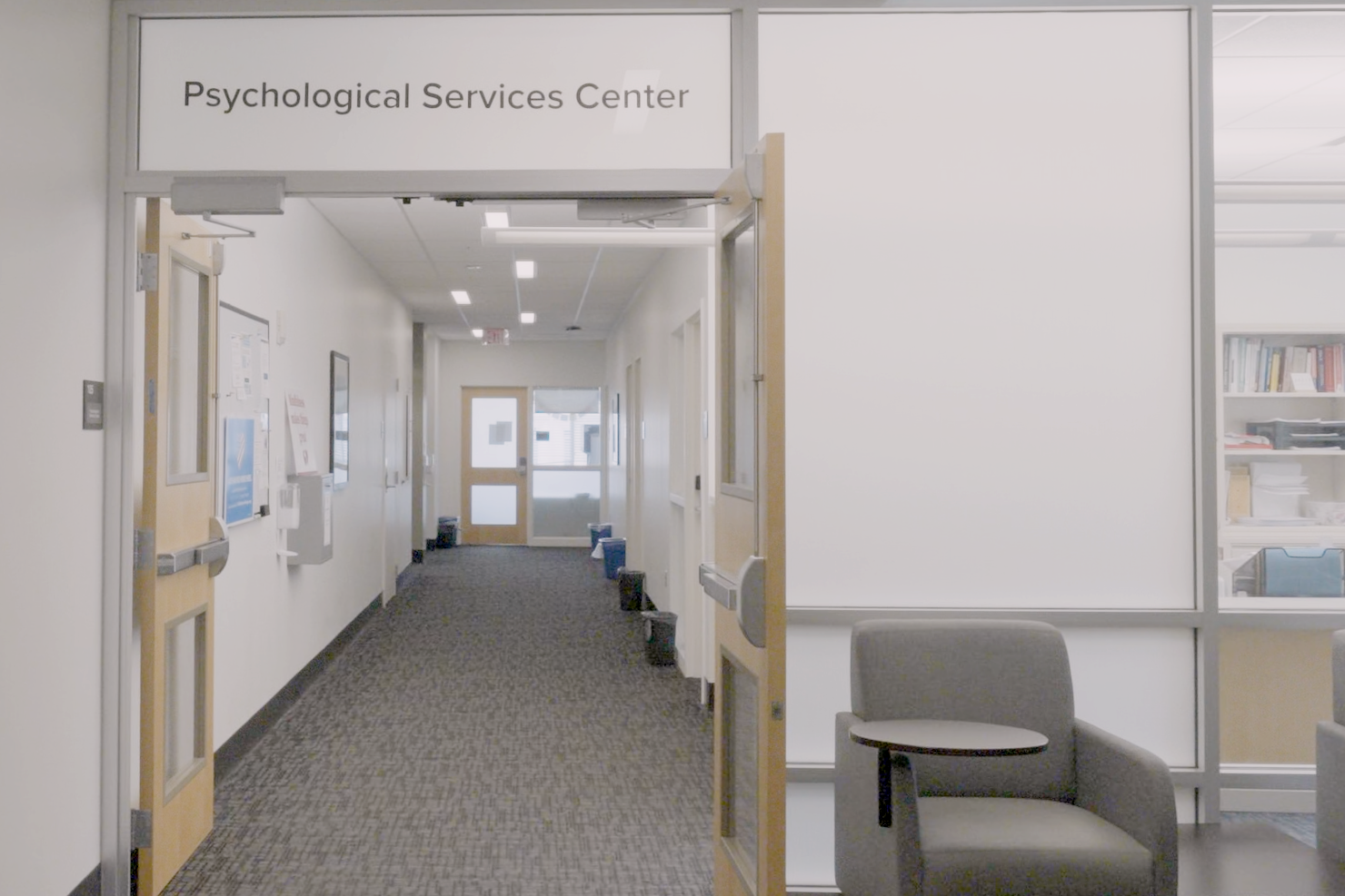 A brightly lit hallway with a sign above it that reads "Psychological Services Center"