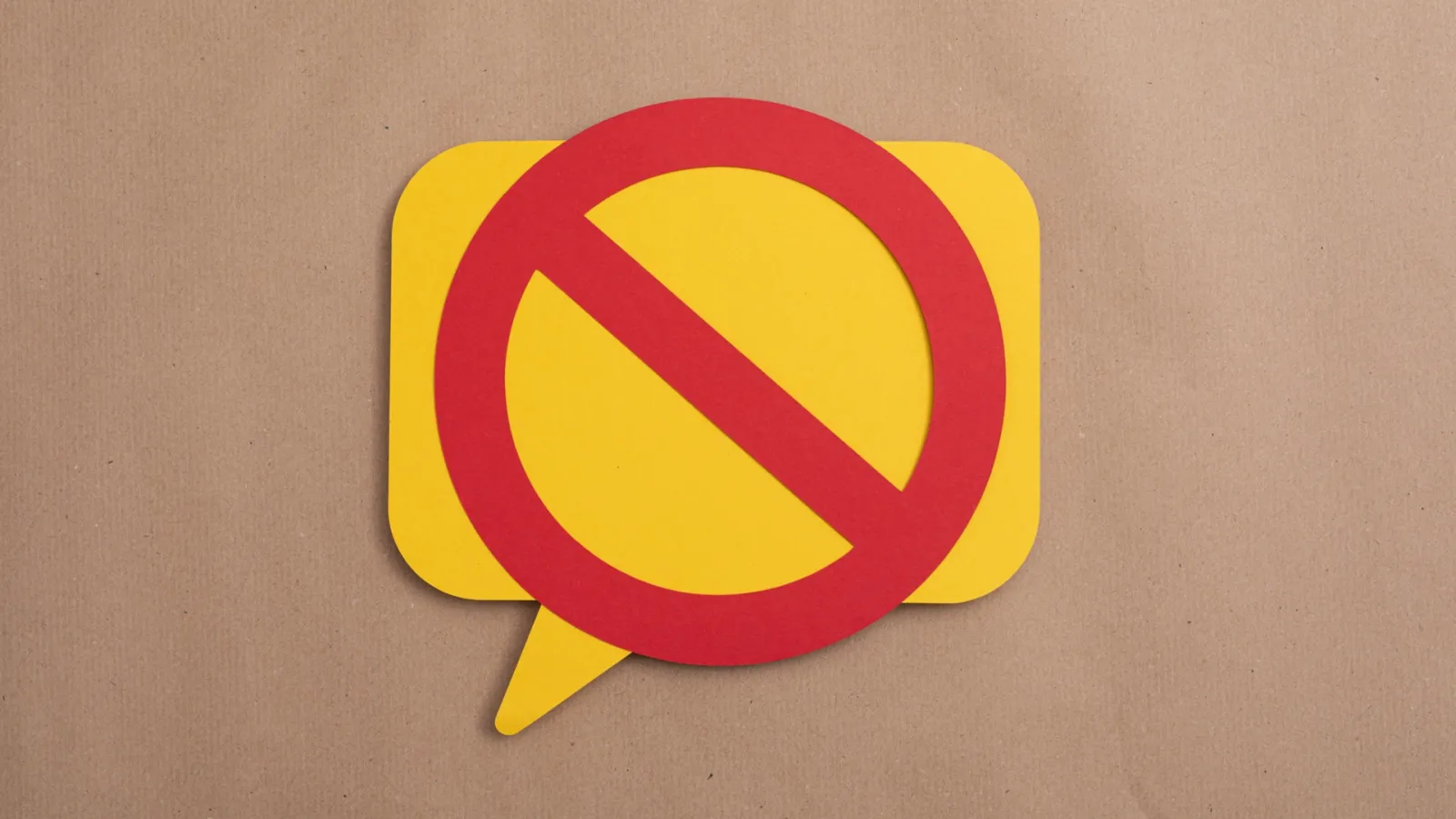 A yellow speech bubble with a red line through it canceling it out.