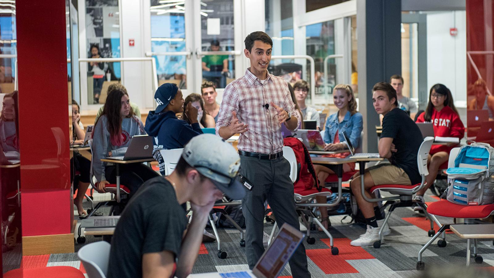 A man lectures in a classroom