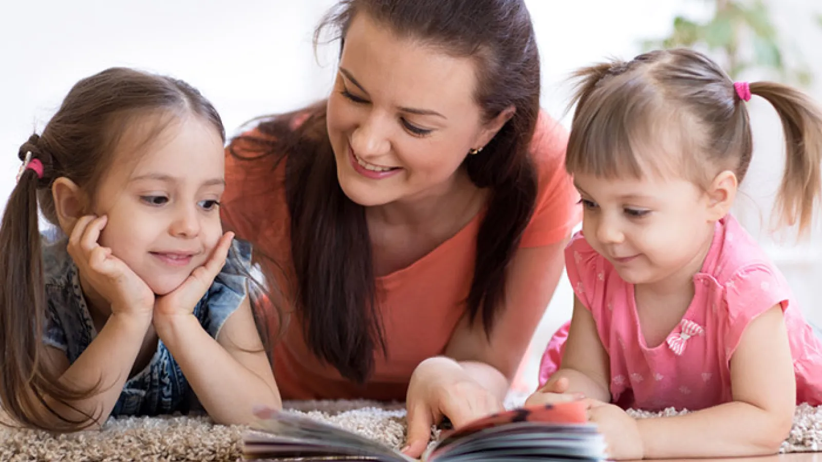 Children reading with mother