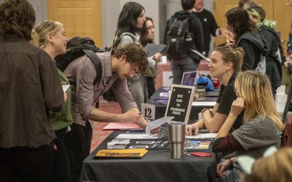 Students talking to employer at a career fair