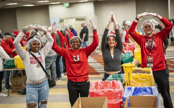 Four students in hair nets spelling O-H-I-O