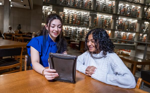 Two Students talking over an iPad