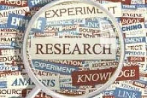 The word "Research" under a magnifying glass