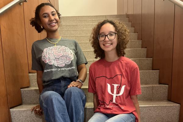 Two Students Wearing Psychology-Themed T-Shirts