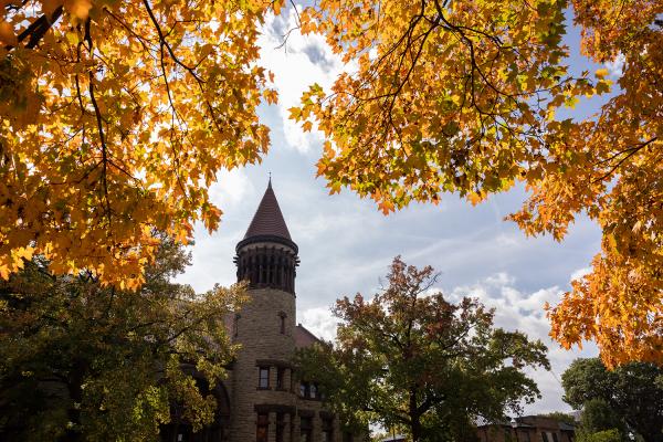 Orton Hall bell tower with yellow autumn foliage in the foreground
