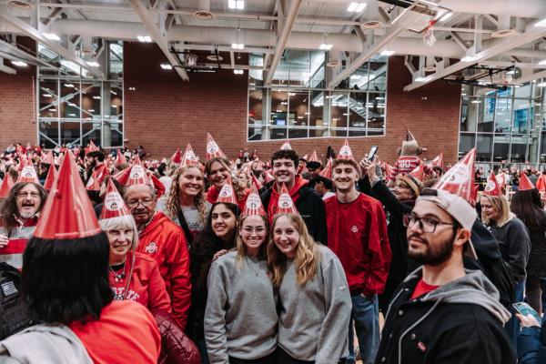 Crowd of people wearing conical hats