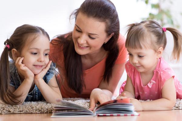 Children reading with mother